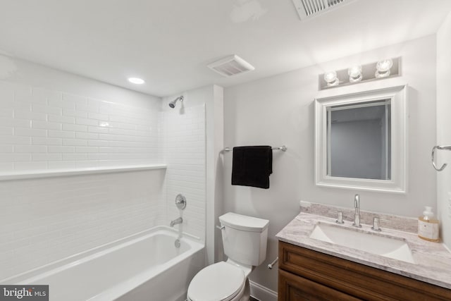 full bathroom featuring tiled shower / bath, vanity, and toilet