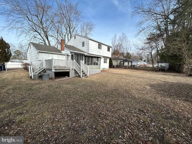 back of house with a deck and a sunroom