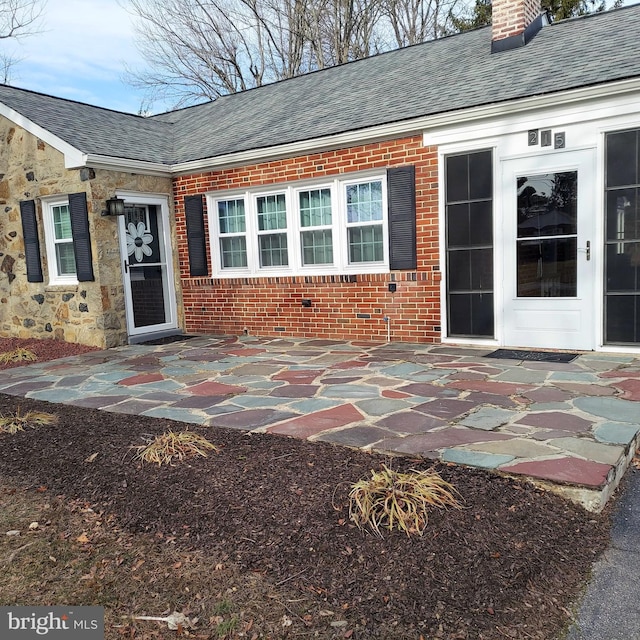 view of exterior entry featuring a patio