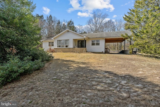 view of front of property featuring a carport and brick siding