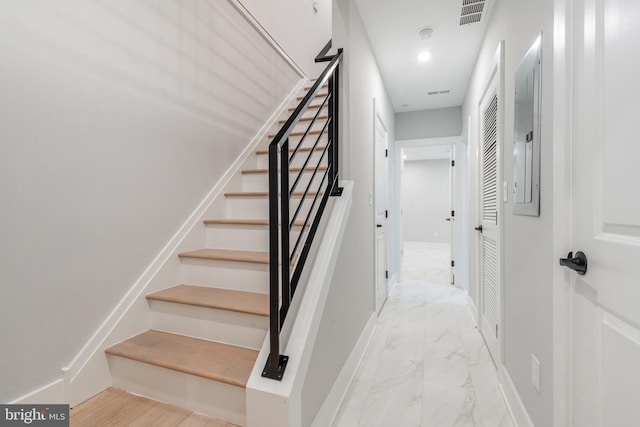 stairway featuring marble finish floor, visible vents, and baseboards