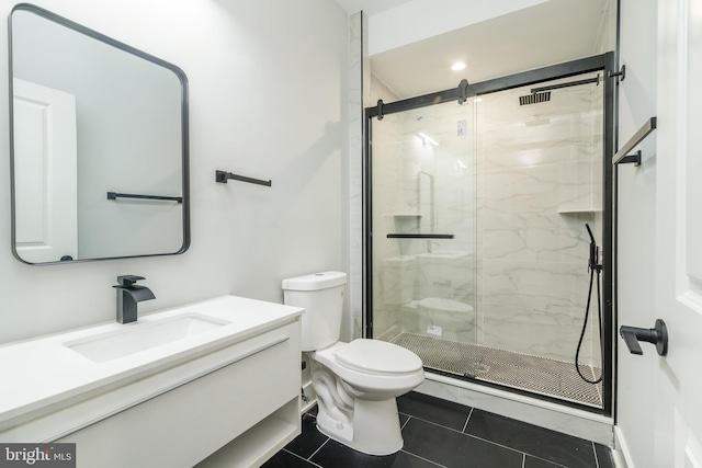 bathroom featuring toilet, tile patterned flooring, a marble finish shower, and vanity