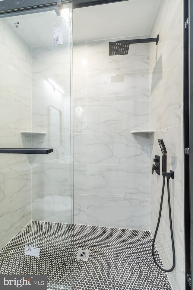 full bathroom with a marble finish shower