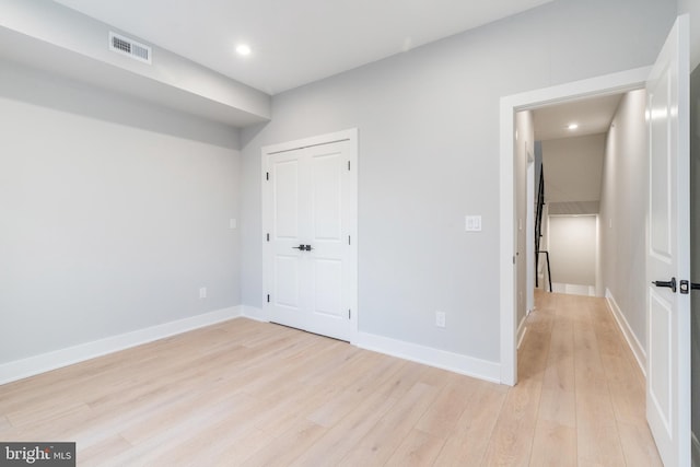 unfurnished bedroom featuring light wood-type flooring, visible vents, and baseboards