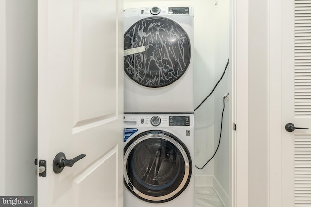 clothes washing area with laundry area and stacked washer / drying machine