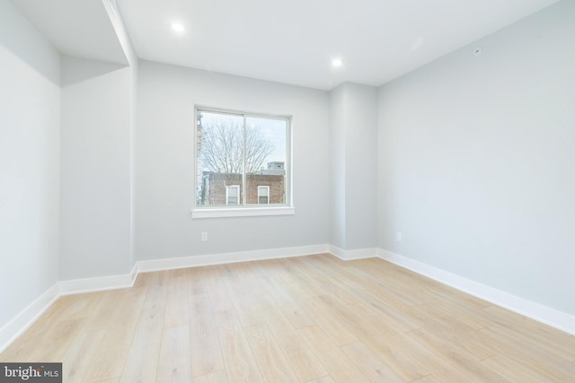 unfurnished room with recessed lighting, baseboards, and light wood finished floors