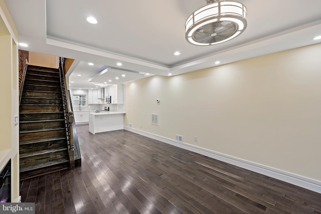 718 Collington Ave, Baltimore, MD 21205 - unfurnished living room featuring a raised ceiling and dark hardwood / wood-style floors