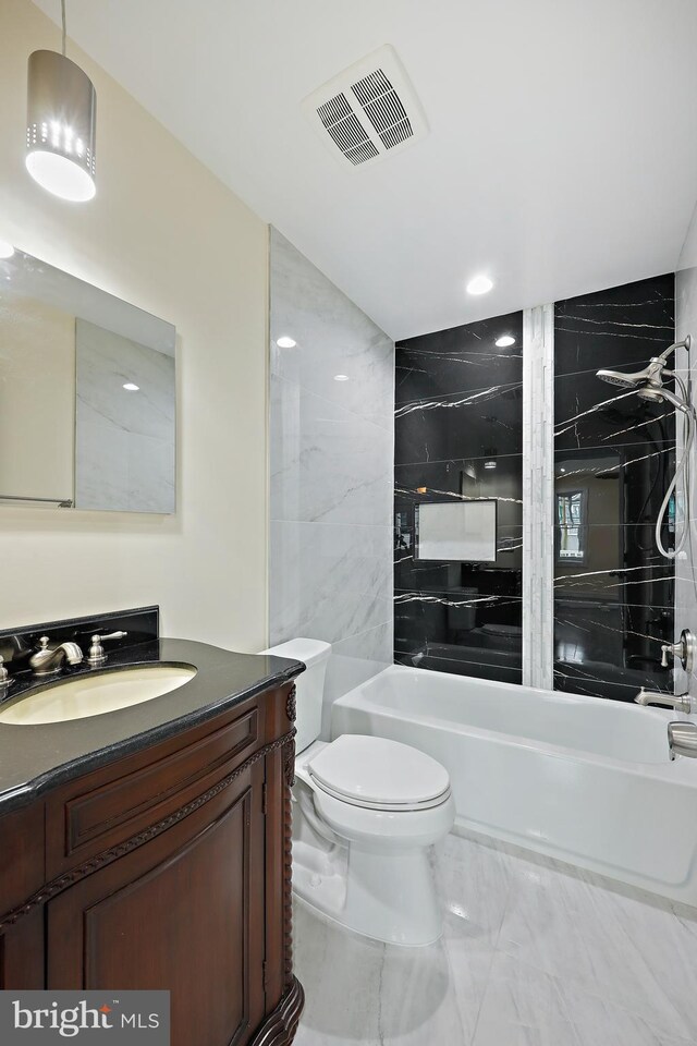 718 Collington Ave, Baltimore, MD 21205 - full bathroom with tiled shower / bath combo, vanity, and toilet