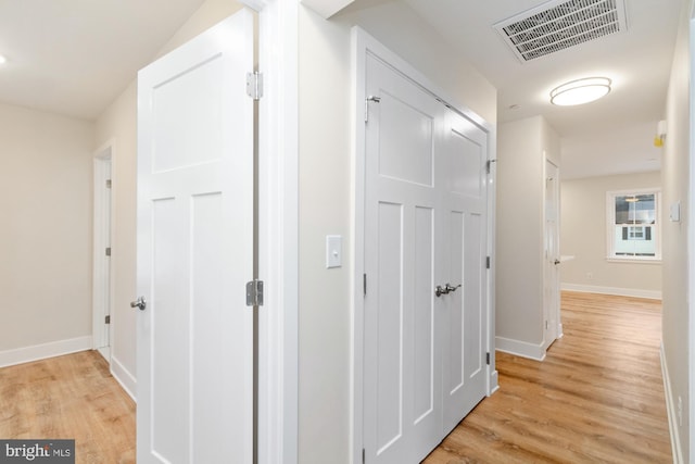 corridor with light hardwood / wood-style floors