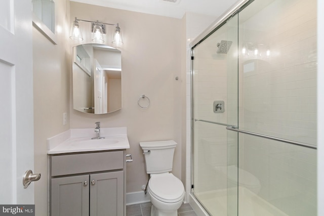 bathroom with vanity, toilet, and an enclosed shower