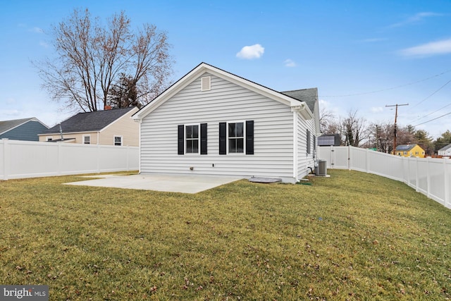 rear view of property featuring a patio and a lawn