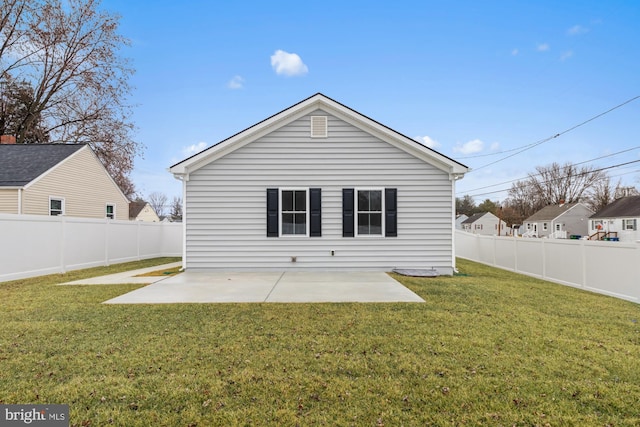 back of property with a lawn and a patio area