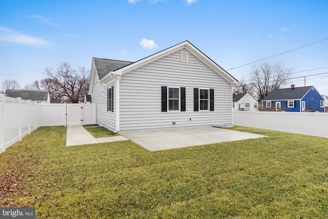 rear view of house with a lawn and a patio