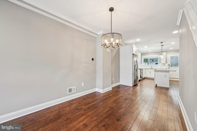 interior space with ornamental molding and dark hardwood / wood-style floors