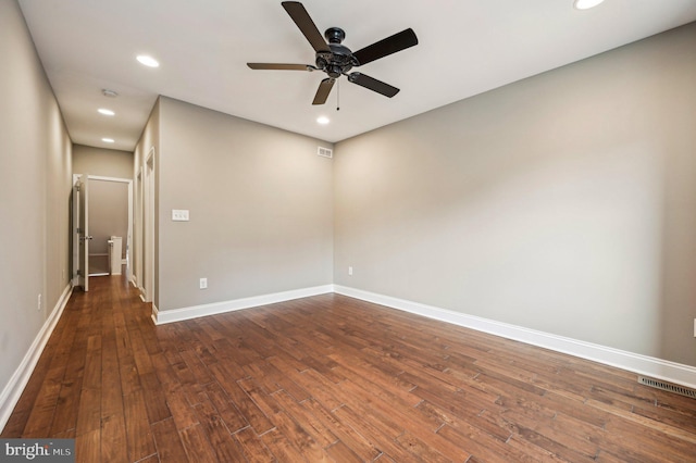 spare room with ceiling fan and dark hardwood / wood-style flooring