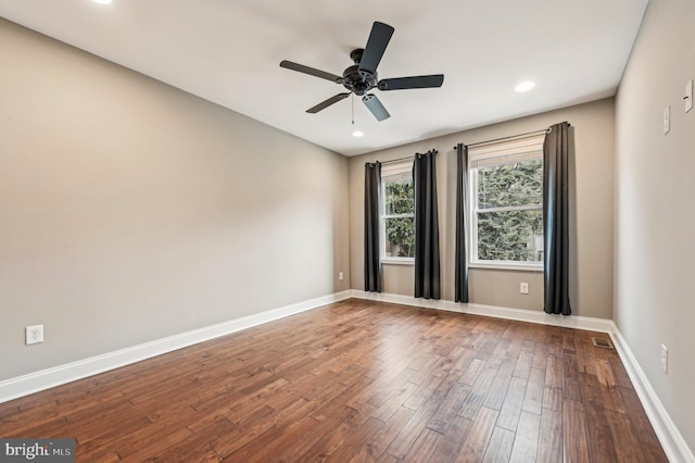 empty room with hardwood / wood-style flooring and ceiling fan