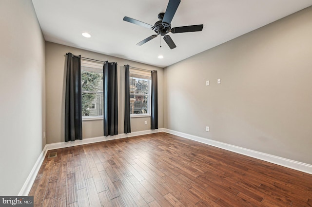 unfurnished room featuring dark hardwood / wood-style floors and ceiling fan