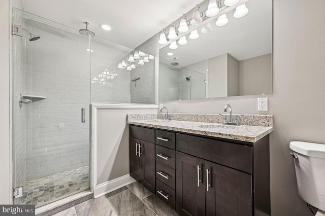 bathroom featuring vanity, toilet, and a shower with door