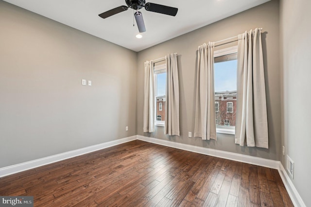 unfurnished room with ceiling fan and dark hardwood / wood-style flooring