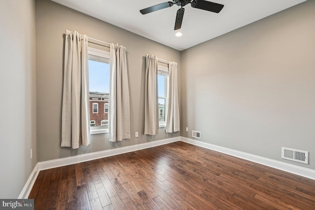 unfurnished room with dark wood-type flooring and ceiling fan