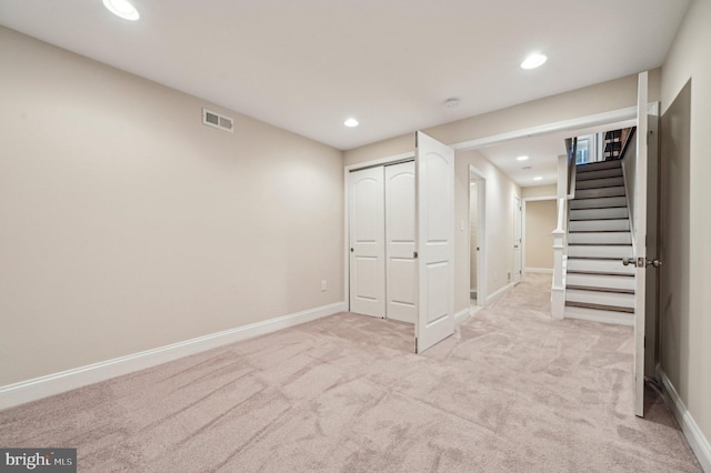 basement featuring light colored carpet