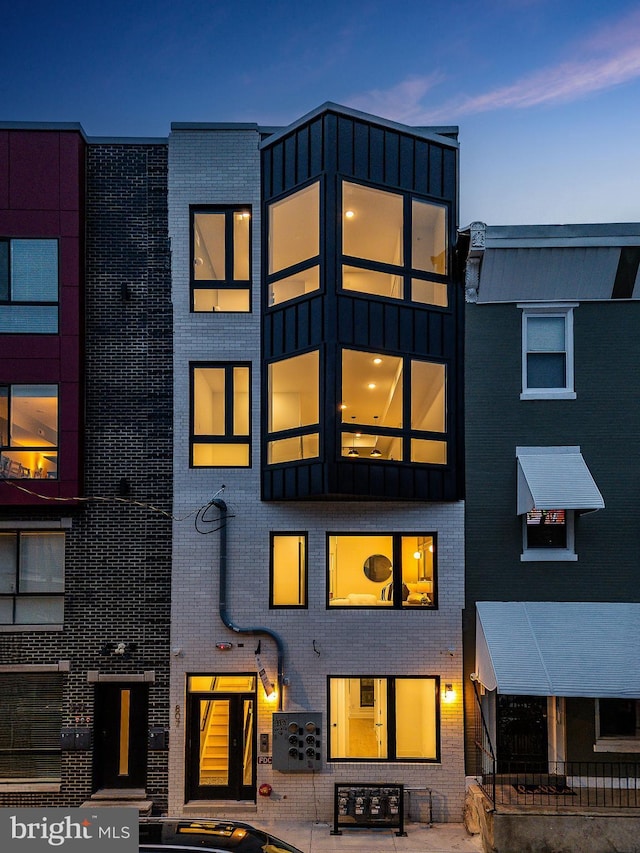 view of back house at dusk