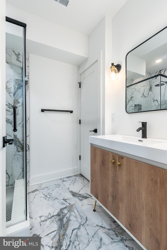 bathroom featuring vanity and an enclosed shower