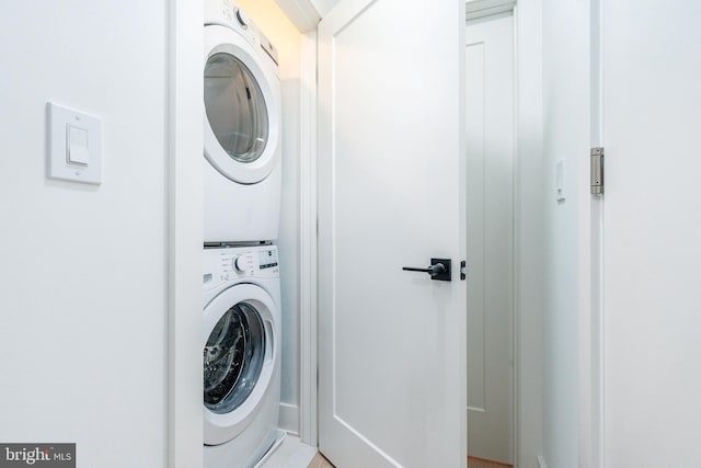 clothes washing area with stacked washer / drying machine