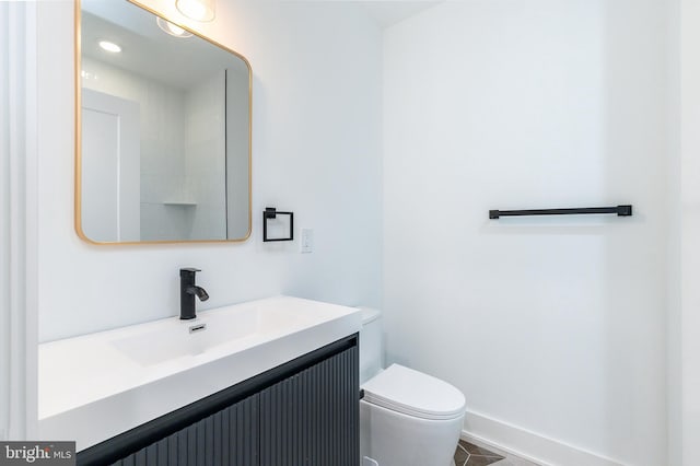 bathroom featuring tile patterned flooring, vanity, and toilet