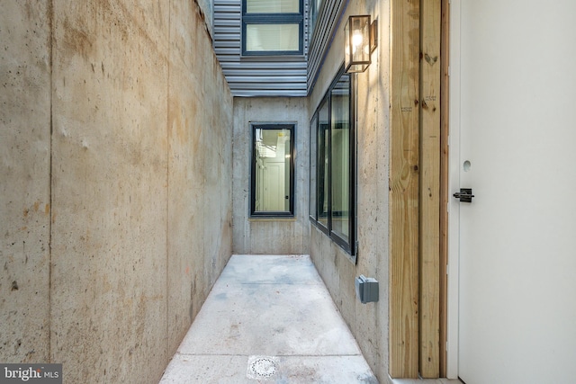 hall featuring concrete flooring