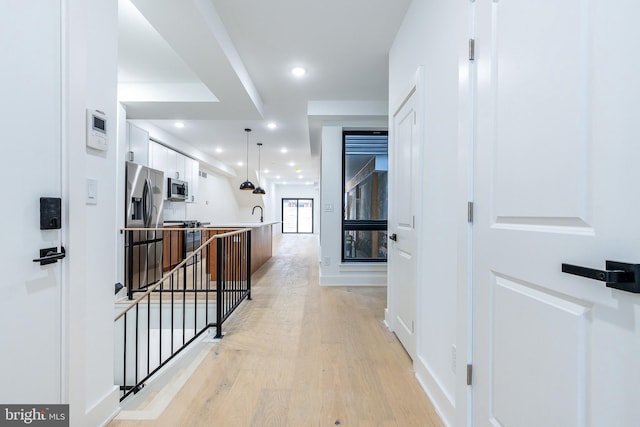 hall with light hardwood / wood-style floors