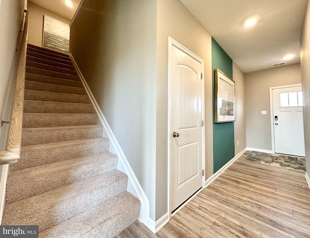 stairs with hardwood / wood-style flooring