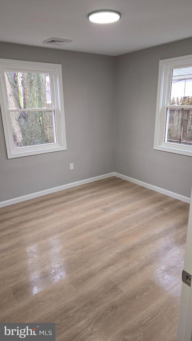 unfurnished room with light hardwood / wood-style floors