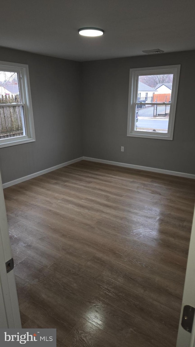 unfurnished room featuring dark hardwood / wood-style flooring