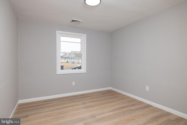 unfurnished room with light hardwood / wood-style floors