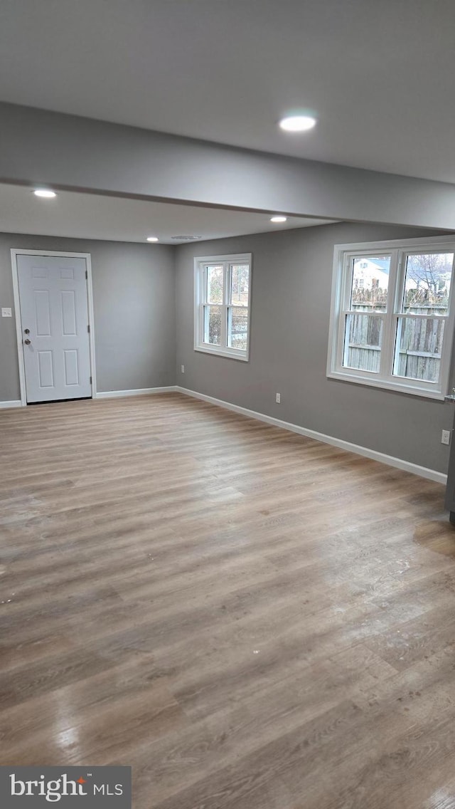 basement with light hardwood / wood-style floors