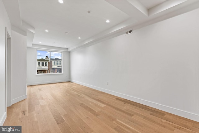 empty room with recessed lighting, visible vents, light wood finished floors, and baseboards