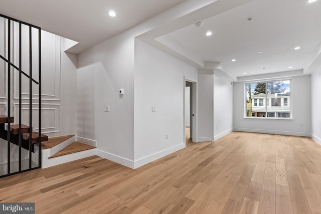 interior space featuring light wood finished floors, recessed lighting, stairs, and baseboards