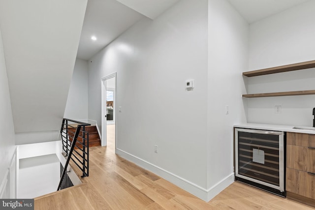 bar with recessed lighting, light wood-type flooring, wine cooler, and baseboards