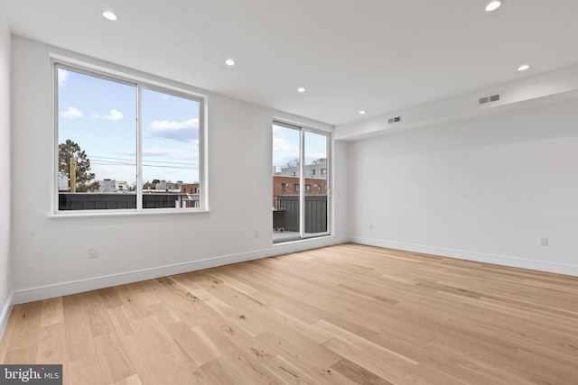 empty room featuring recessed lighting, visible vents, baseboards, and light wood finished floors