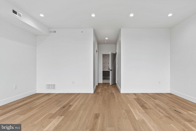 unfurnished room with recessed lighting, visible vents, and light wood-style flooring