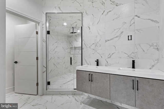 full bathroom with a marble finish shower, marble finish floor, and dual sinks