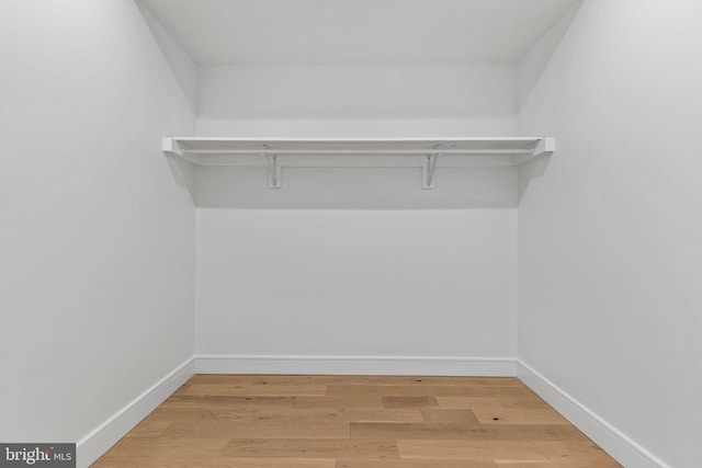 spacious closet with wood finished floors