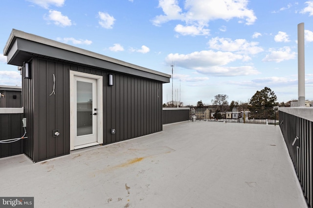 back of house with a patio area and board and batten siding