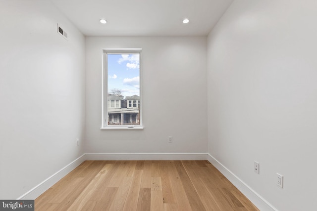 unfurnished room with light wood-type flooring, visible vents, baseboards, and recessed lighting