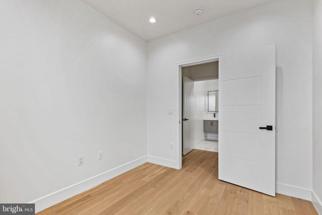 unfurnished bedroom featuring baseboards and light wood finished floors