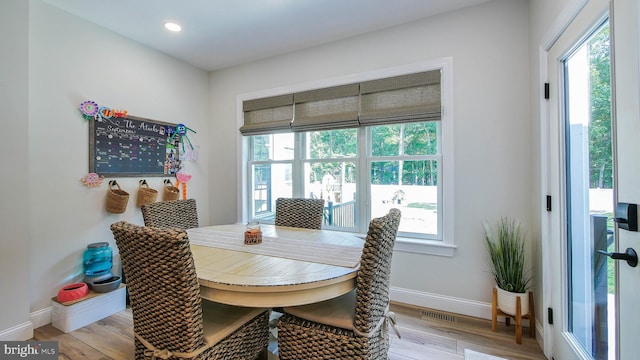 dining room with plenty of natural light and light wood-type flooring