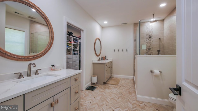 bathroom with walk in shower, parquet floors, and vanity