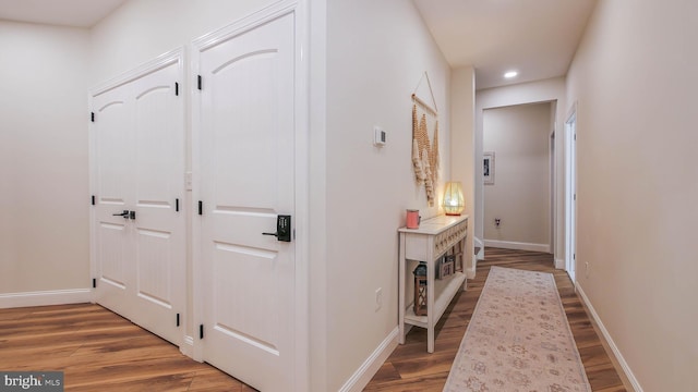 hall with hardwood / wood-style flooring