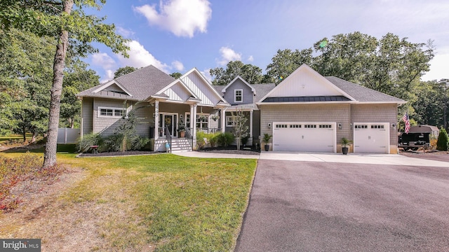 craftsman-style house featuring a garage and a front yard